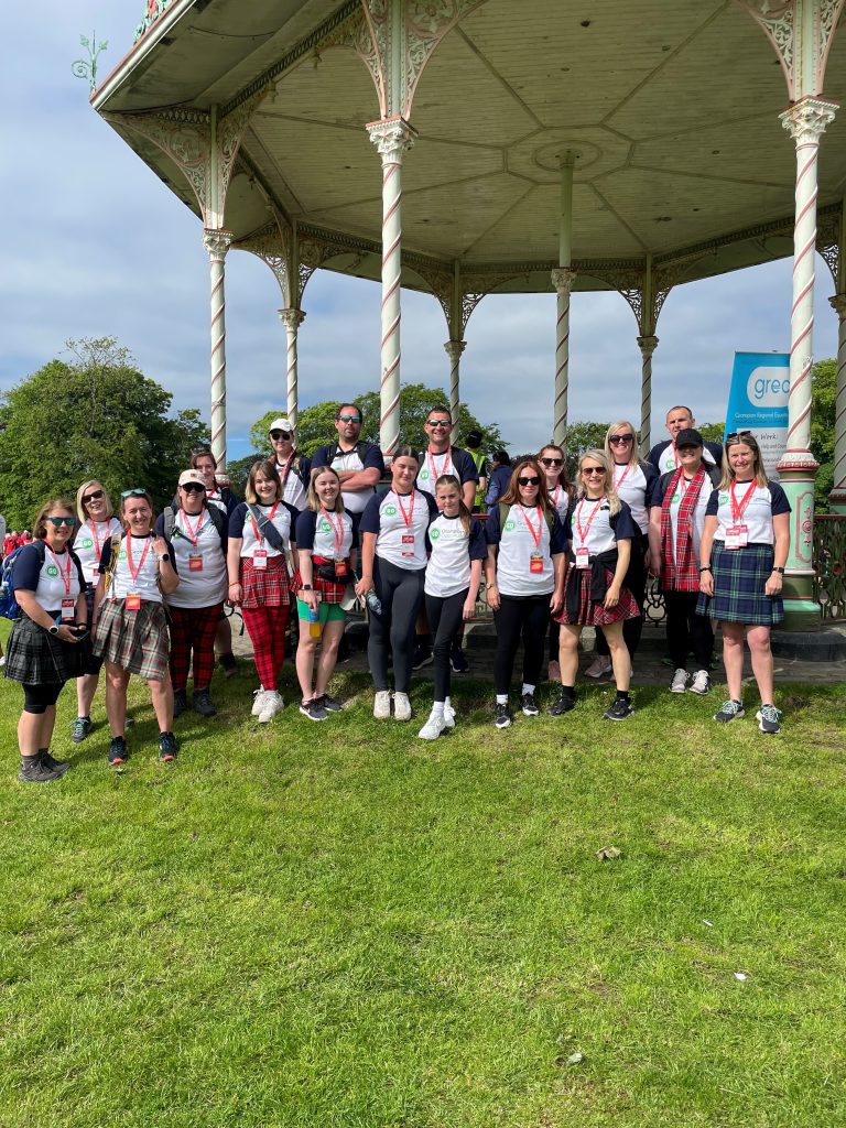 Kiltwalk 2024 team posing on the grass at Duthie Park in Aberdeen.