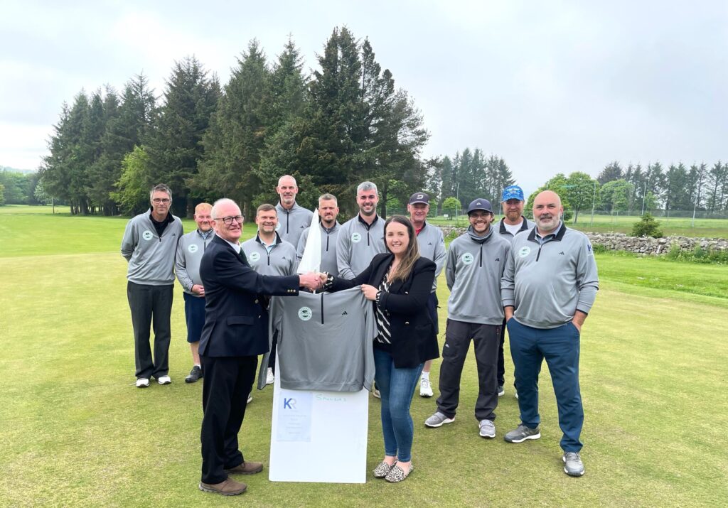 KR Group with sponsored pennant team, posing on Auchmill golf course in Aberdeen, holding new team tops they provided.