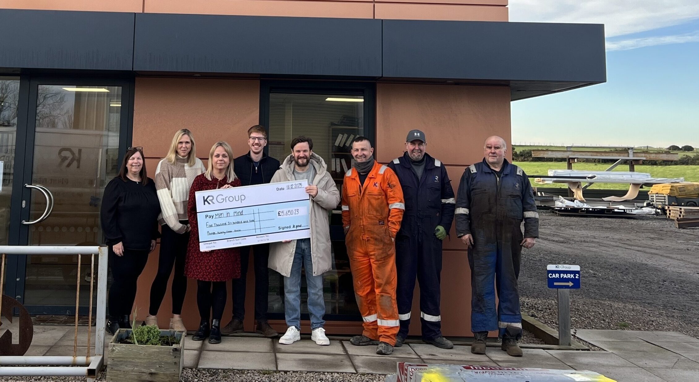 KR Group presenting Men in Mind with cheque after fundraising efforts in 2025.